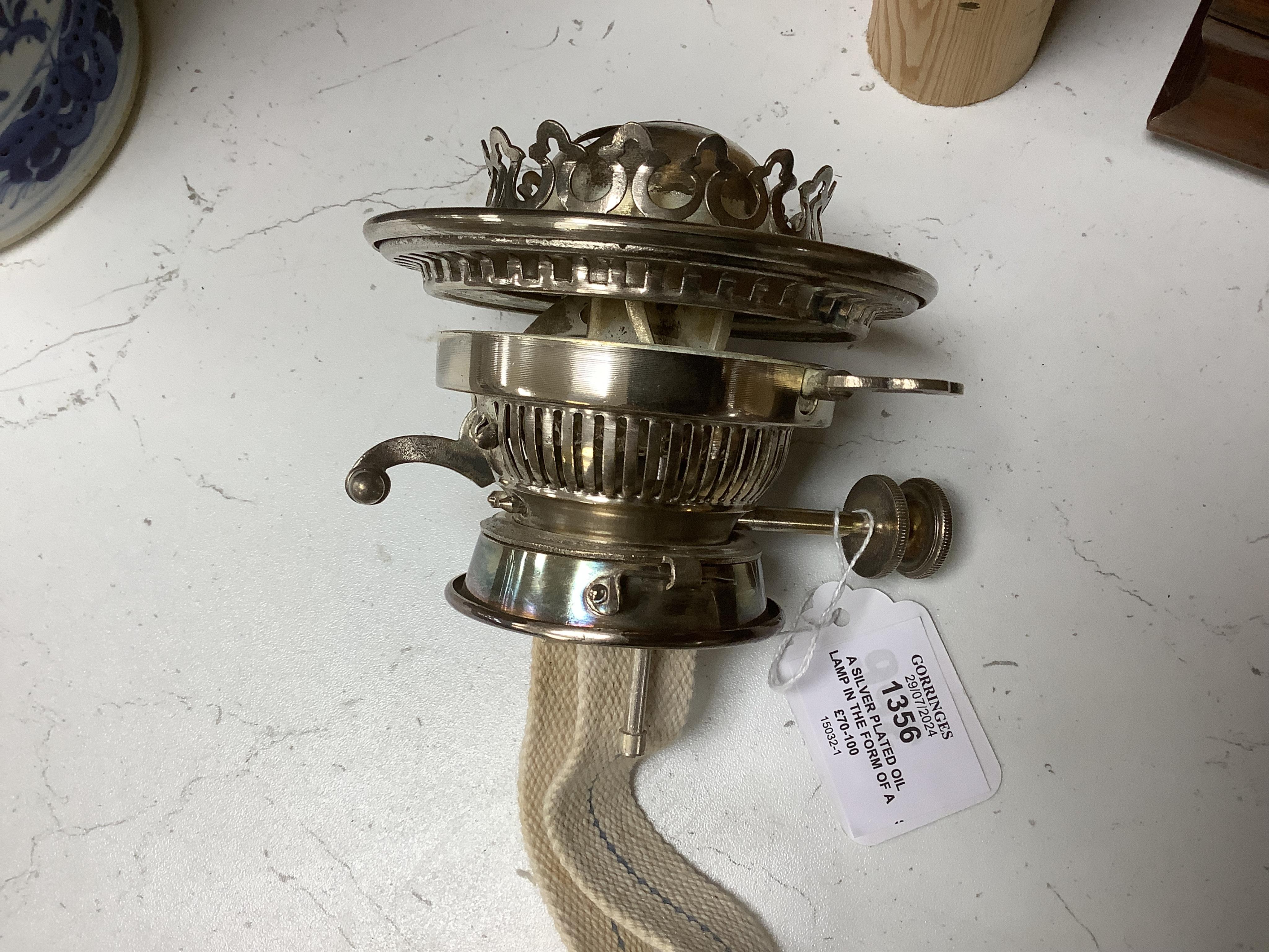 A silver plated oil lamp in the form of a Corinthian column with cut glass reservoir, 76cm high. Condition - fair to good, missing chimney and shade